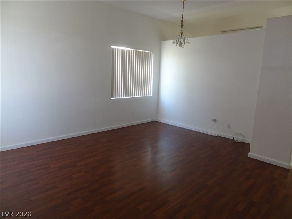 1199 Sunfire Street Henderson, NV 89014 - Photo 2 of 11 Unfurnished room with lofted ceiling and dark wood-style flooring
