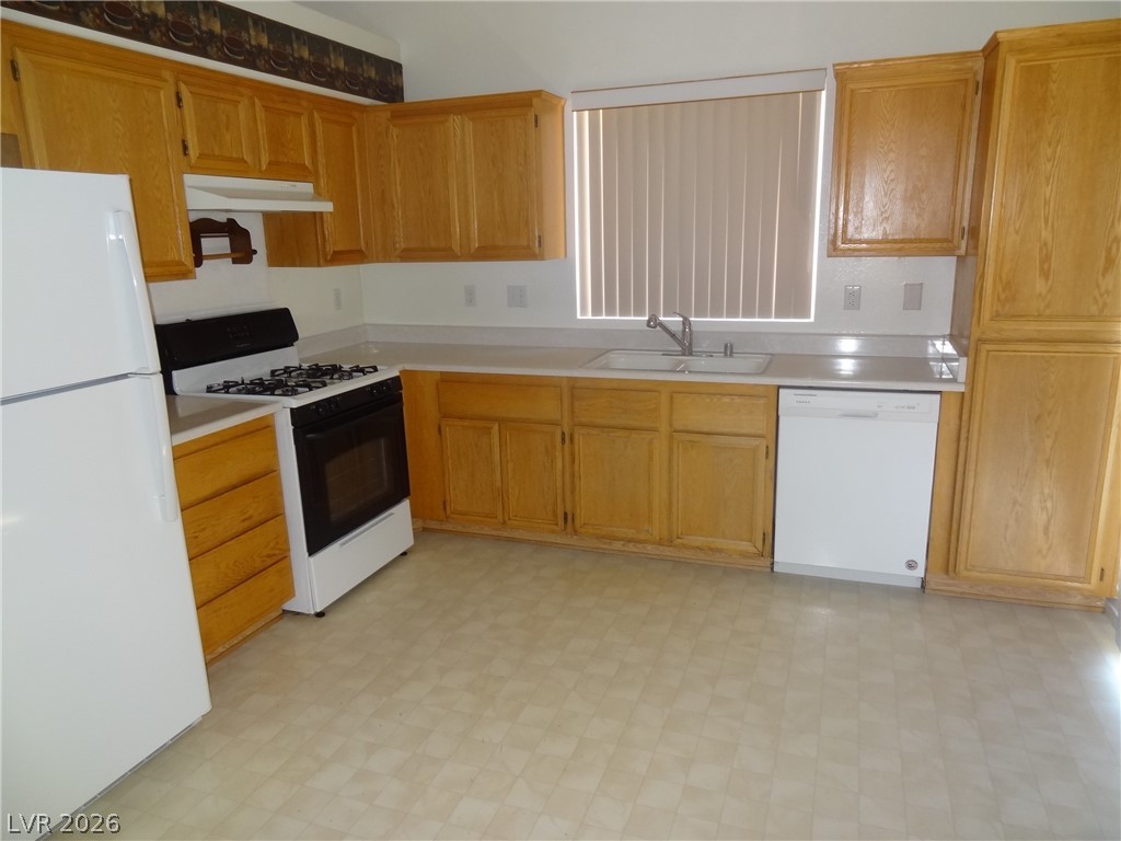 1199 Sunfire Street Henderson, NV 89014 - Photo 5 of 11 Kitchen featuring white appliances, light floors, and light countertops