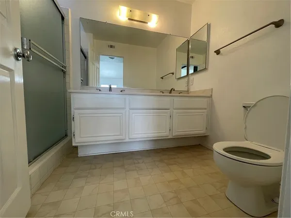 a bathroom with a sink a toilet and mirror