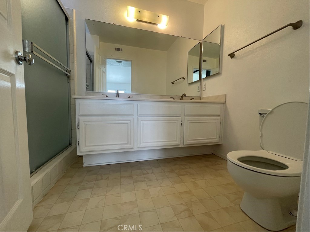 16 Wellesley Irvine, CA 92612 - Photo 14 of 25 a bathroom with a sink a toilet and mirror