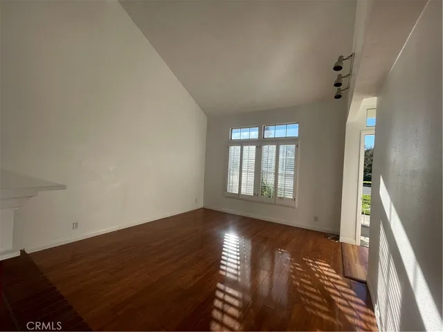 a view of wooden floor and windows in a room