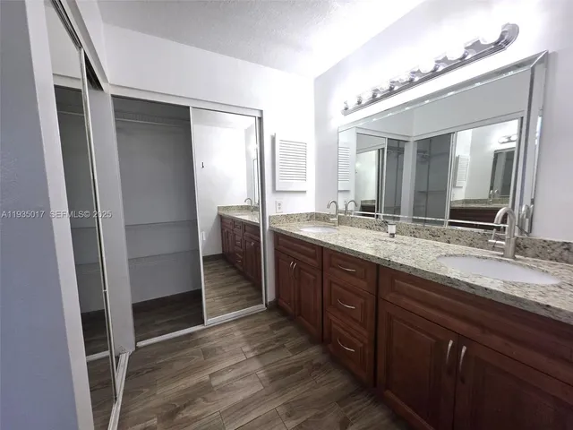 a bathroom with a double vanity sink and a mirror