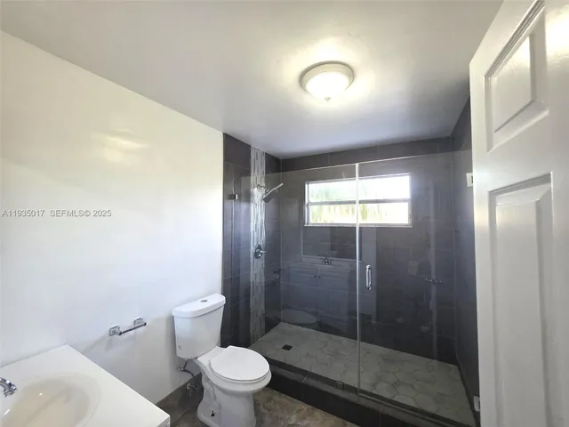 a bathroom with a shower and a toilet