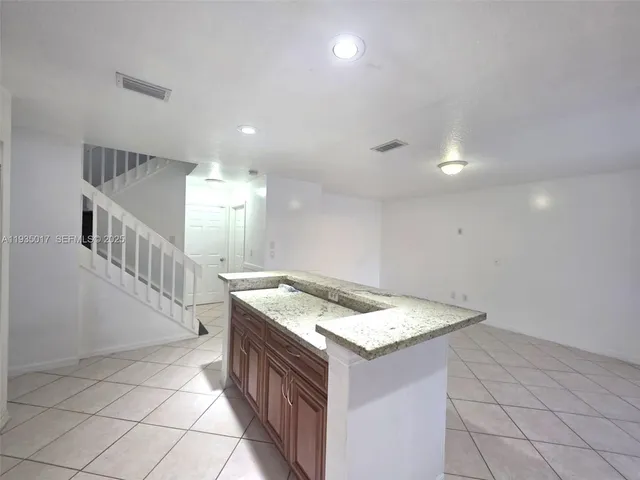 a kitchen that has a sink and a stove in it