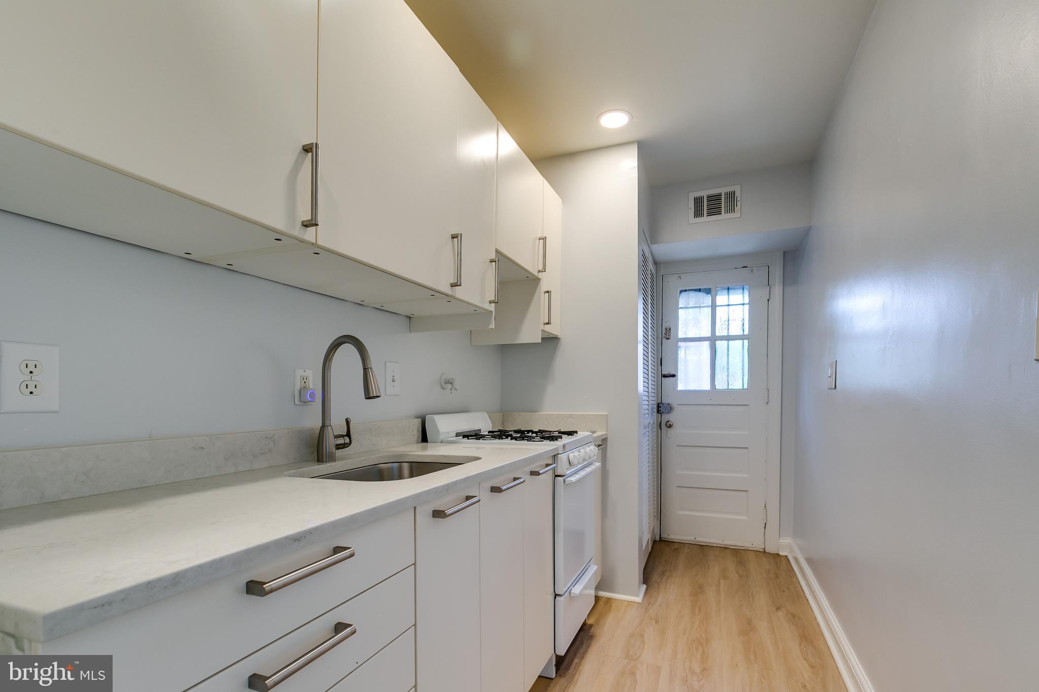 118 P Street Southwest Washington, DC 20024 - Photo 4 of 23 a kitchen with stainless steel appliances a sink stove and cabinets