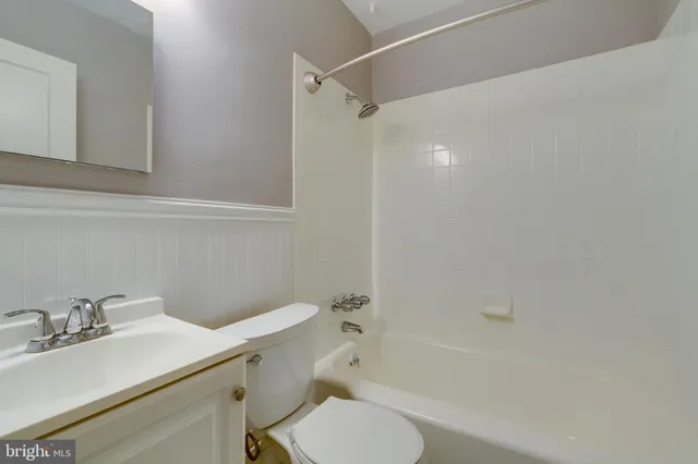 a bathroom with a sink toilet vanity and shower