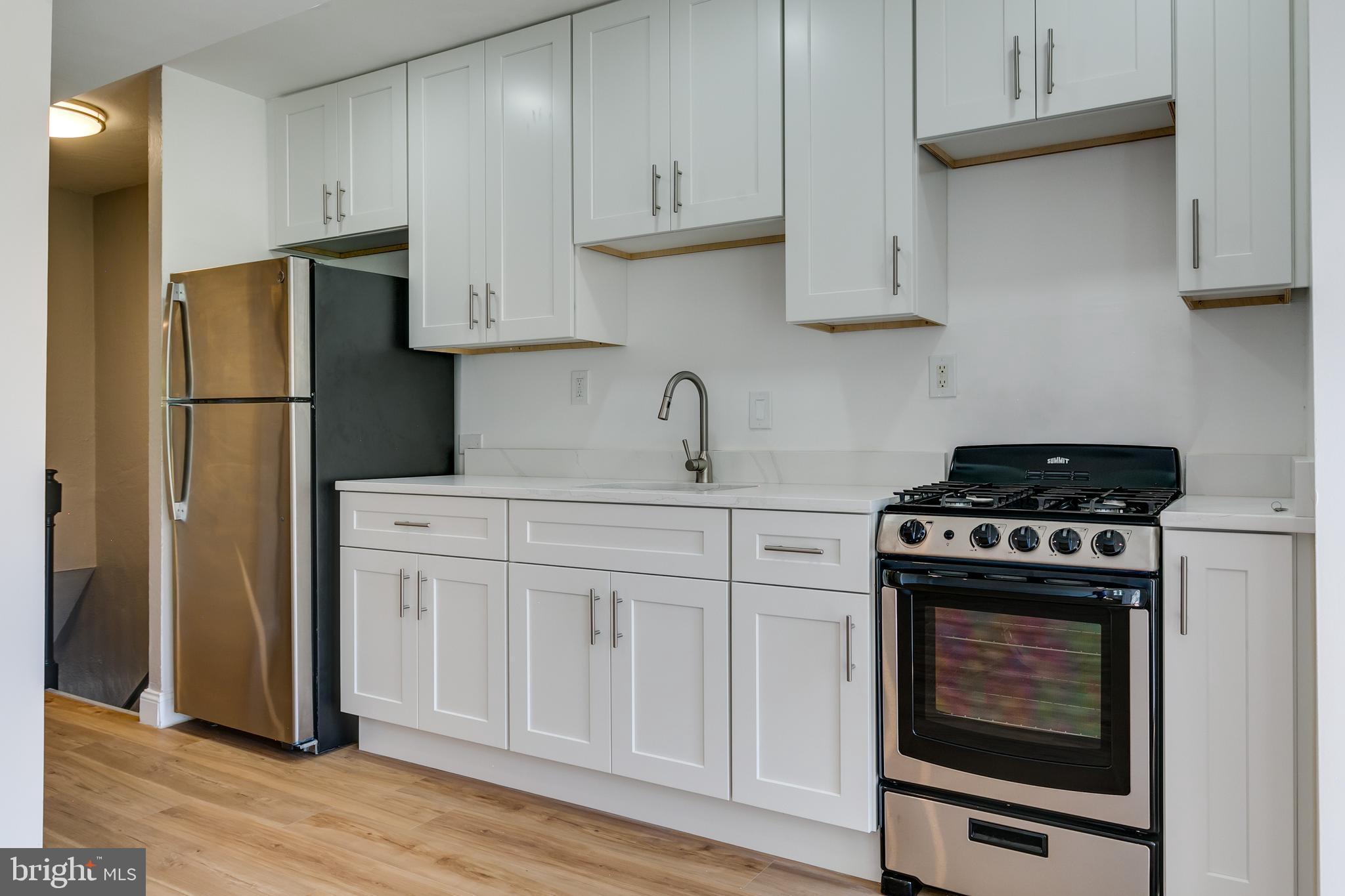 118 P Street Southwest Washington, DC 20024 - Photo 9 of 23 a kitchen with cabinets appliances and wooden floor