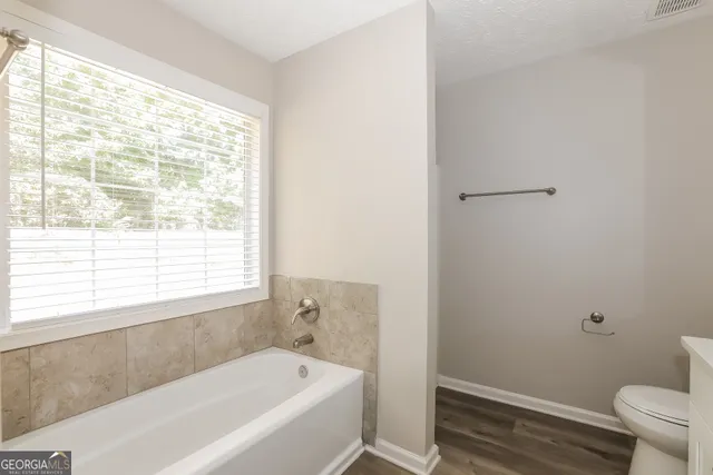 a bathroom with a bathtub and a toilet