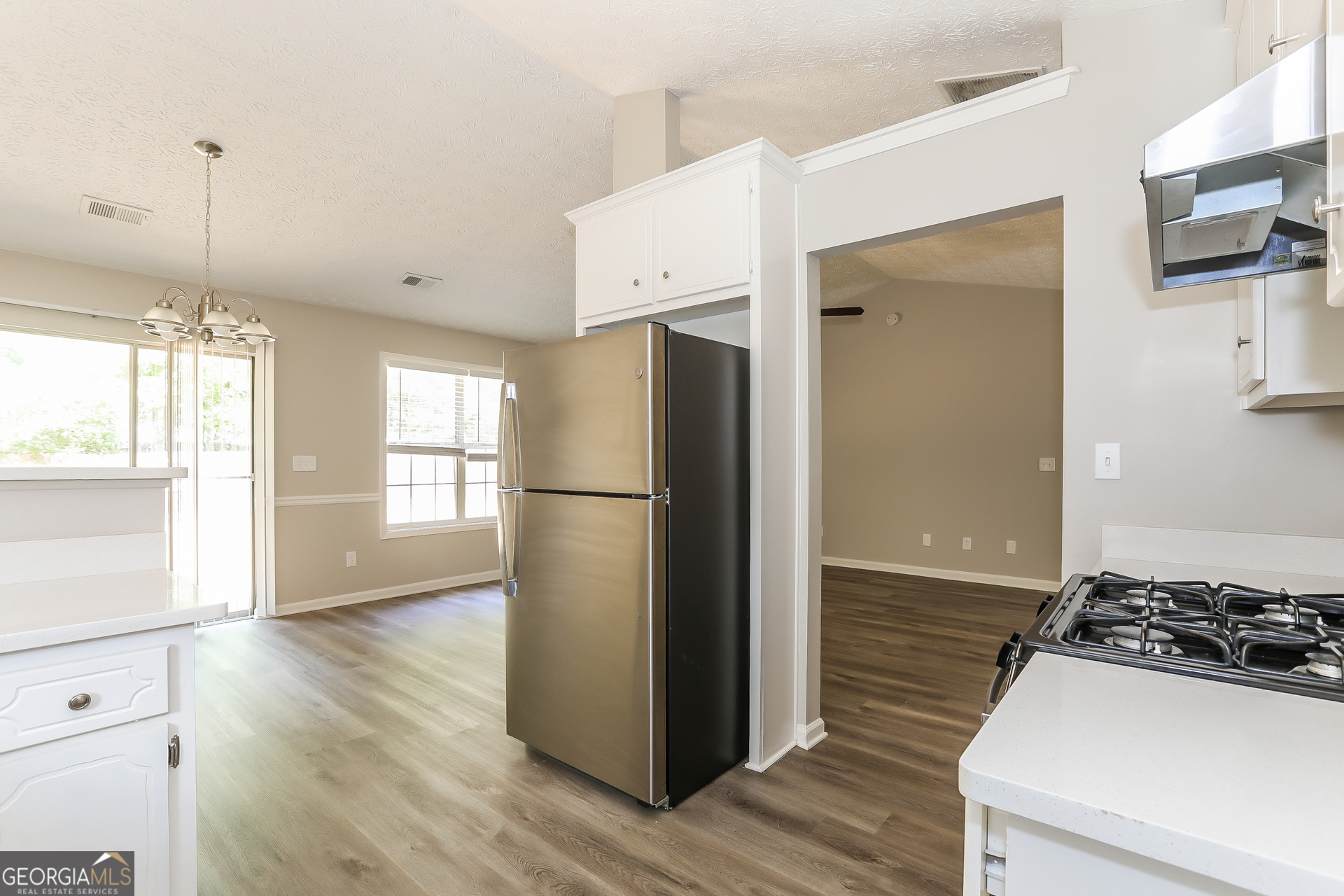 125 Waters Edge Drive Locust Grove, GA 30248 - Photo 5 of 16 a kitchen with a refrigerator and a stove top oven
