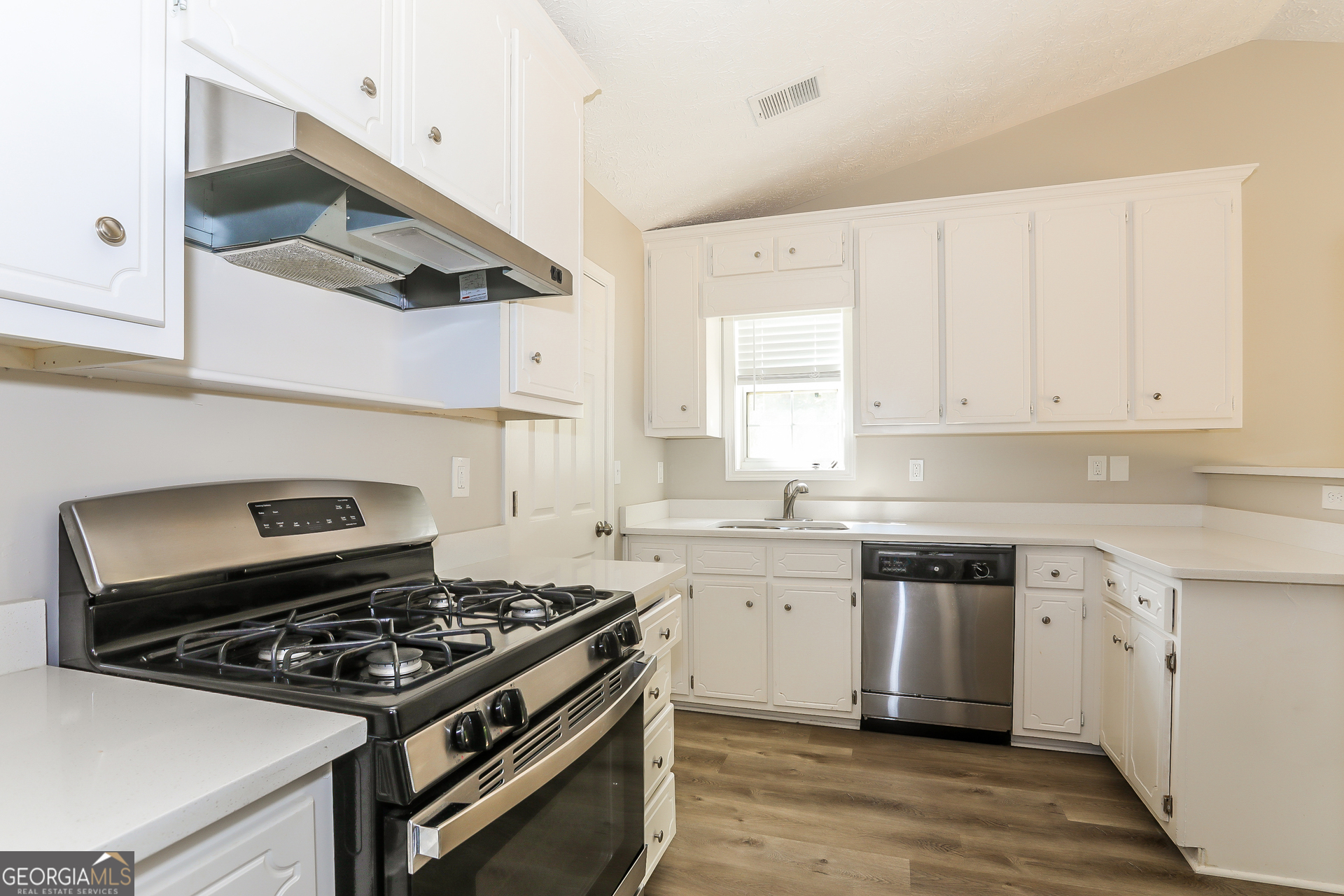 125 Waters Edge Drive Locust Grove, GA 30248 - Photo 6 of 16 a kitchen with a stove and a sink
