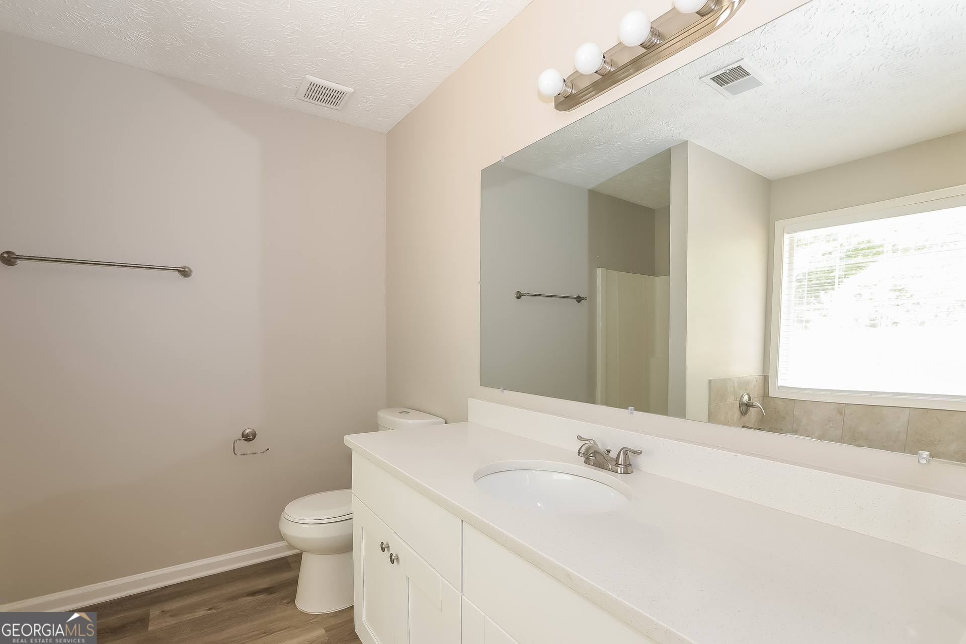 125 Waters Edge Drive Locust Grove, GA 30248 - Photo 9 of 16 a bathroom with a sink and a toilet