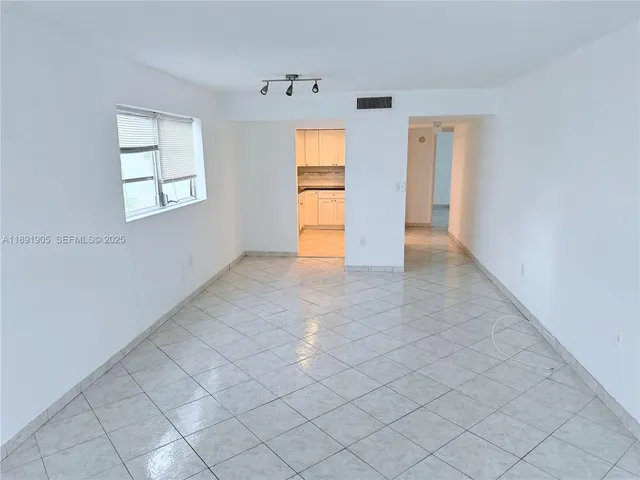a kitchen with granite countertop white cabinets and stainless steel appliances