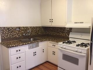 1042 Chula Vista Avenue Burlingame, CA 94010 - Photo 2 of 8 a kitchen with granite countertop white cabinets and white appliances