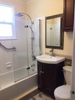 a bathroom with a sink toilet and shower