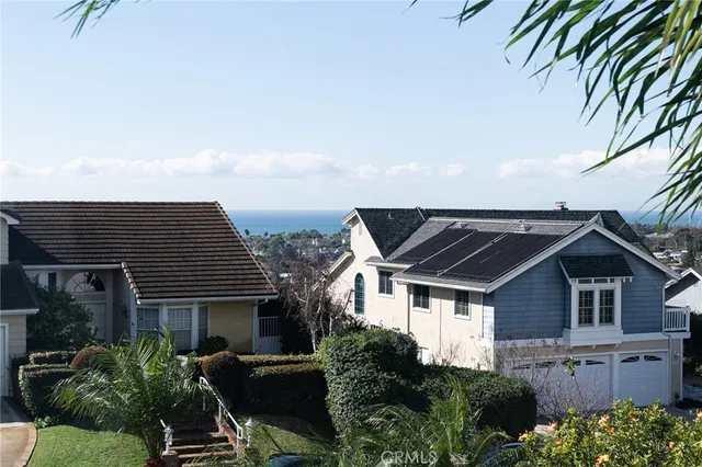 a front view of house with a garden