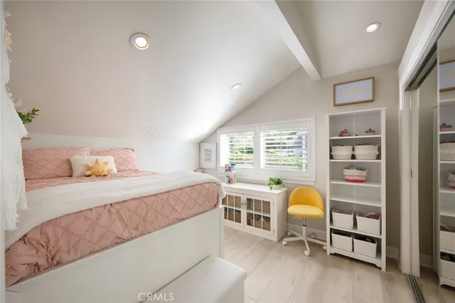 a bed room with a bed and a chair