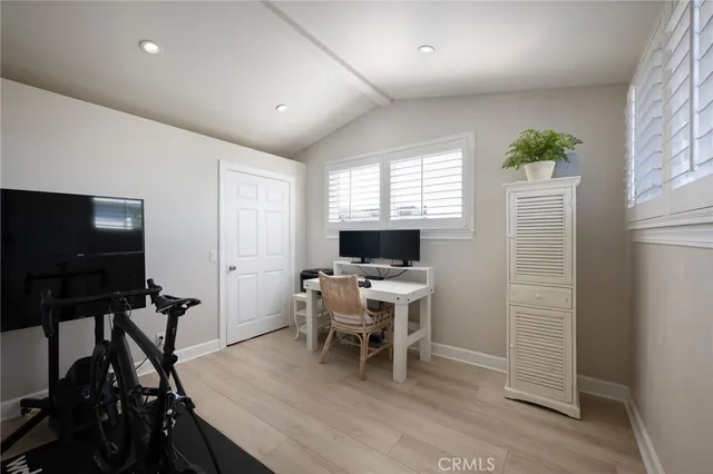 a view of a workspace with furniture and a window