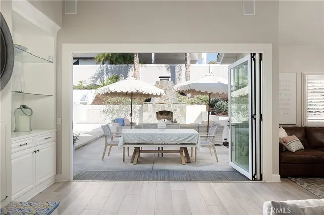 a living room with furniture a patio and a fireplace