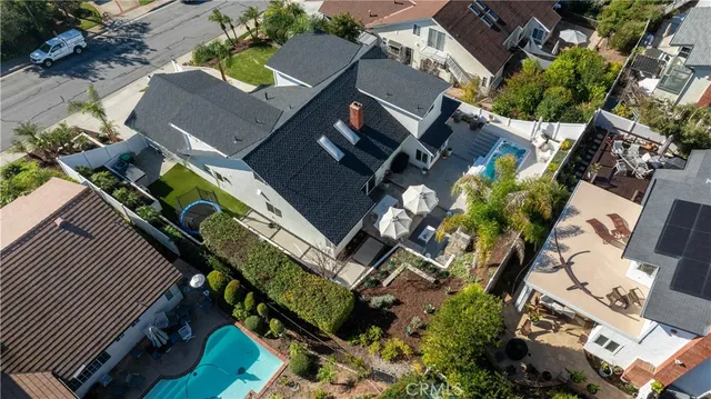 a front view of a house with a yard and potted plants