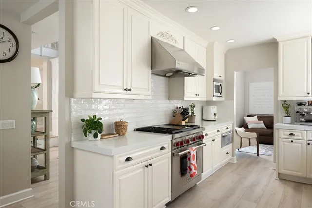 a kitchen with stainless steel appliances granite countertop a stove a sink and a refrigerator