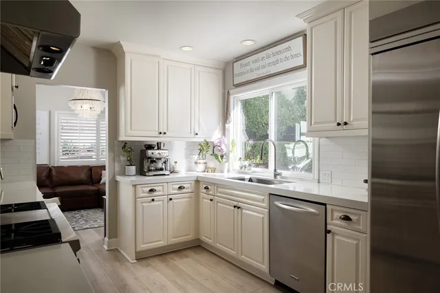 a kitchen with a sink a window and cabinets