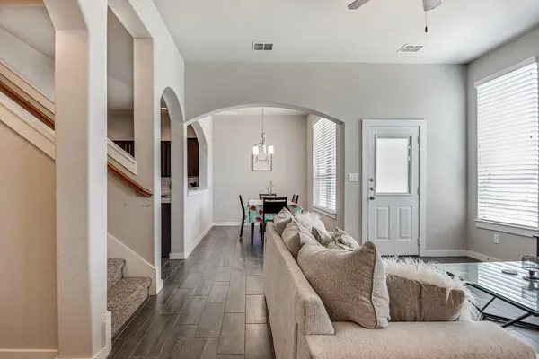 a living room with furniture and a wooden floor