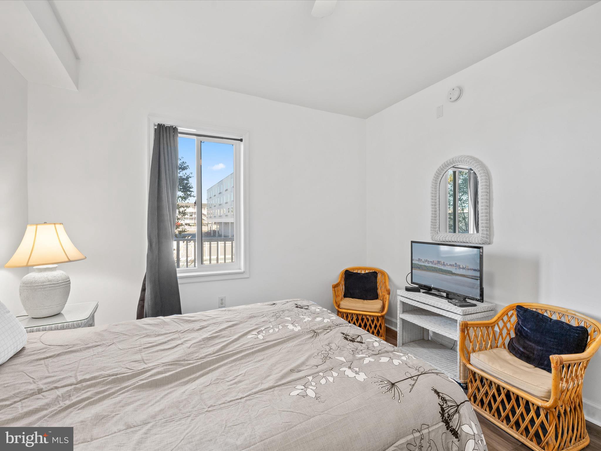 105 56th Street, Unit 205 P1 Ocean City, MD 21842 - Photo 17 of 40 a bedroom with a bed and a window
