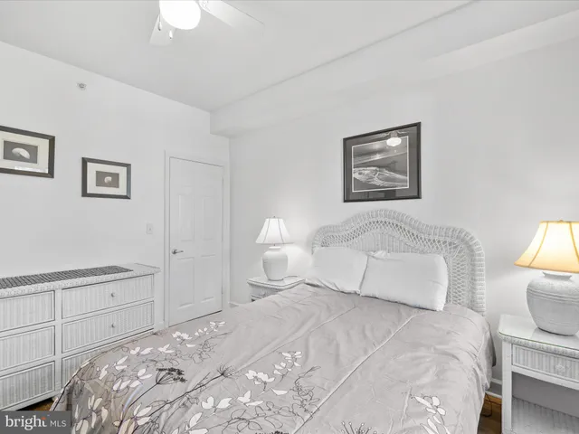 a bedroom with a bed and a lamp