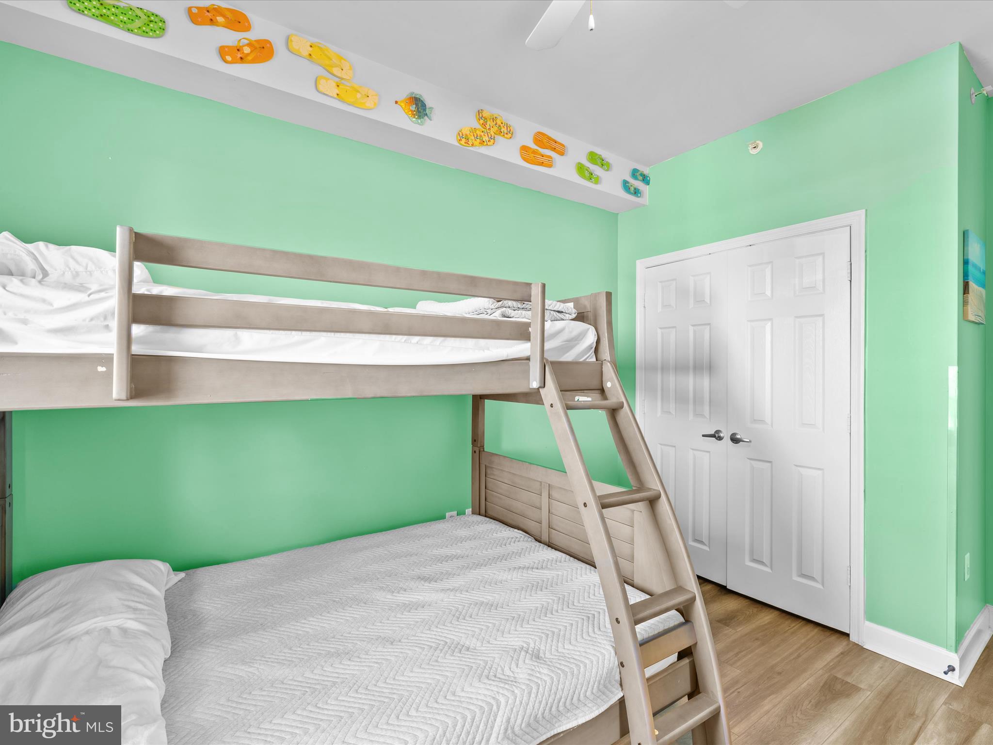 105 56th Street, Unit 205 P1 Ocean City, MD 21842 - Photo 20 of 40 a bedroom with a bed and a wooden floor