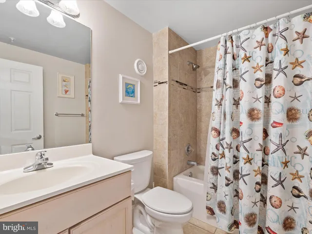 a bathroom with a sink toilet a shower and a mirror