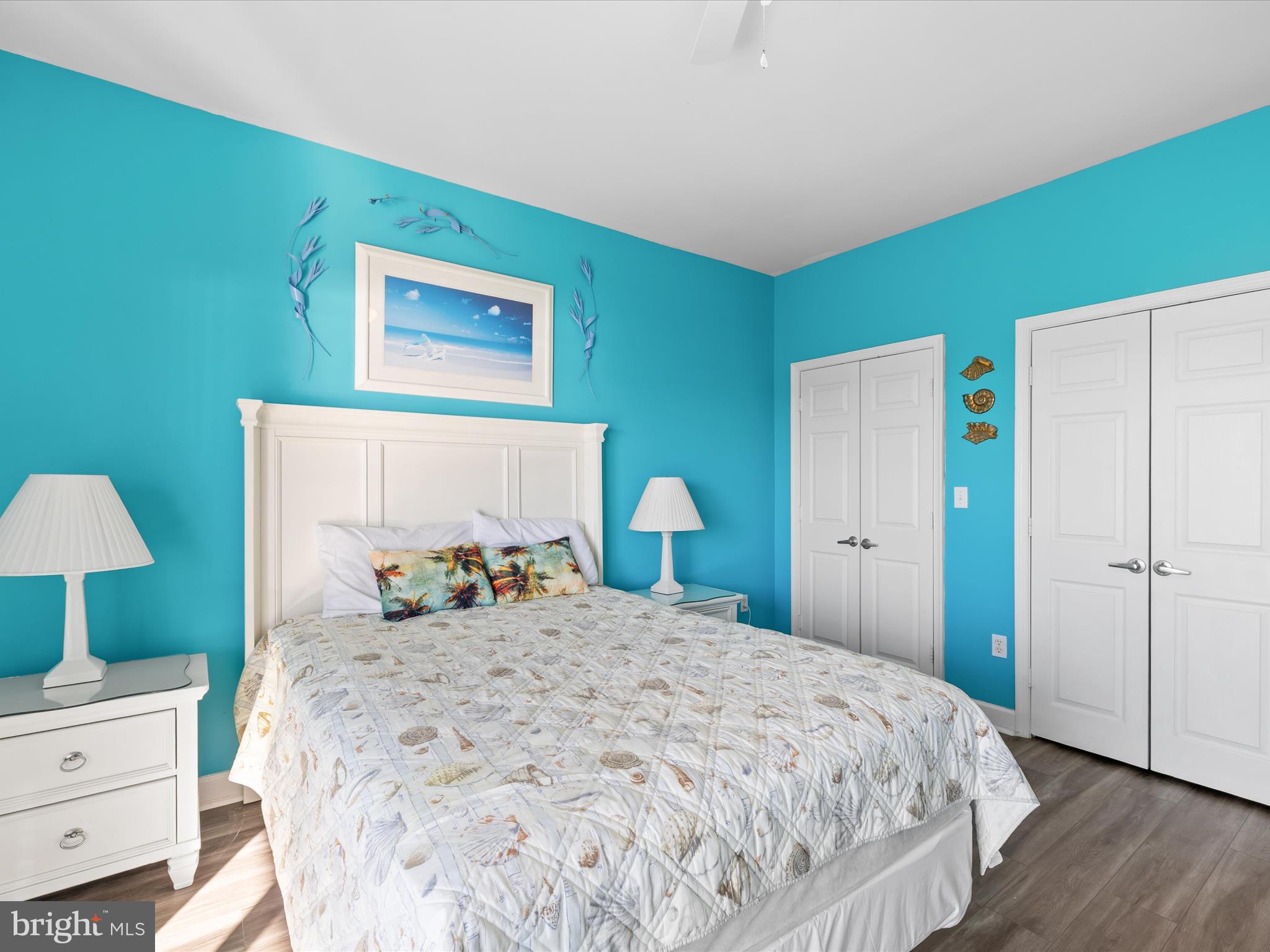 105 56th Street, Unit 205 P1 Ocean City, MD 21842 - Photo 24 of 40 a bedroom with a bed and a lamp