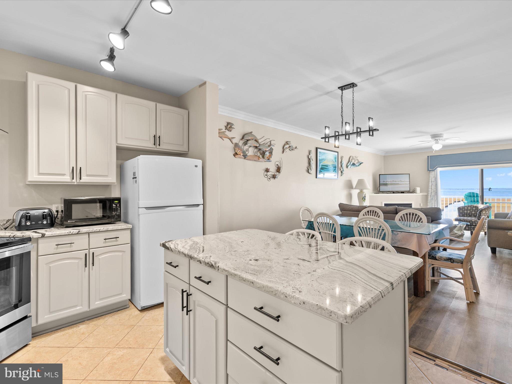 105 56th Street, Unit 205 P1 Ocean City, MD 21842 - Photo 3 of 40 a kitchen with cabinets and stainless steel appliances