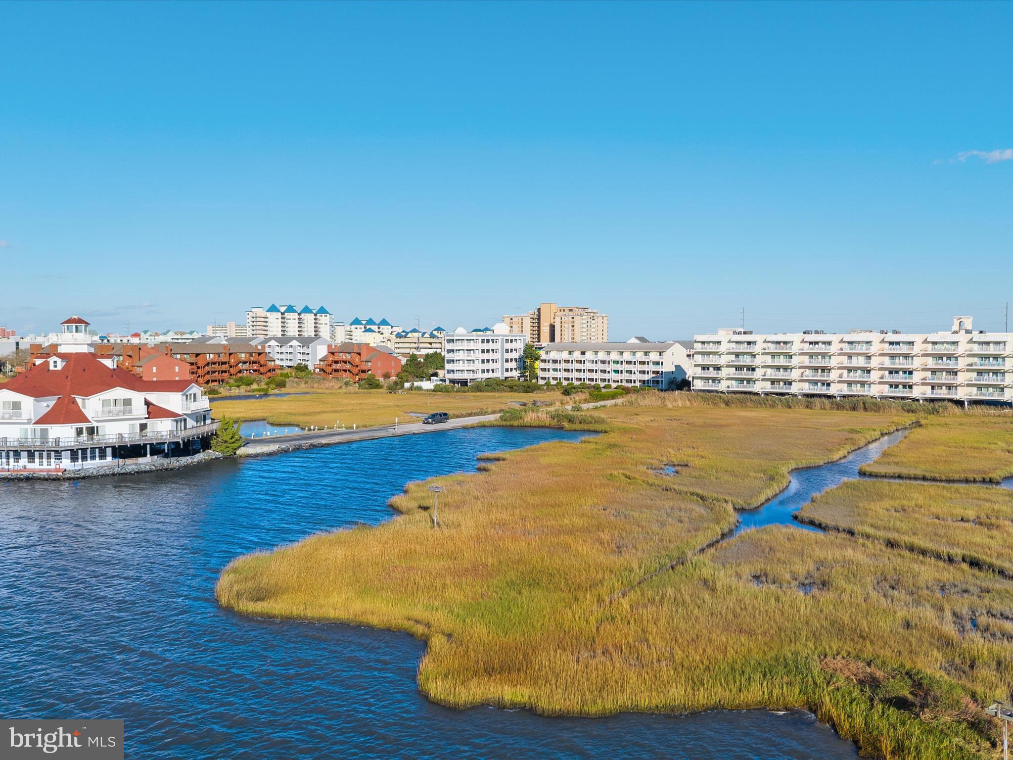 105 56th Street, Unit 205 P1 Ocean City, MD 21842 - Photo 37 of 40 a view of a lake with boats and trees in the background