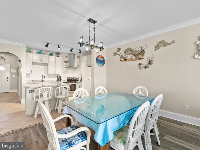 a view of a dining room with furniture and chandelier