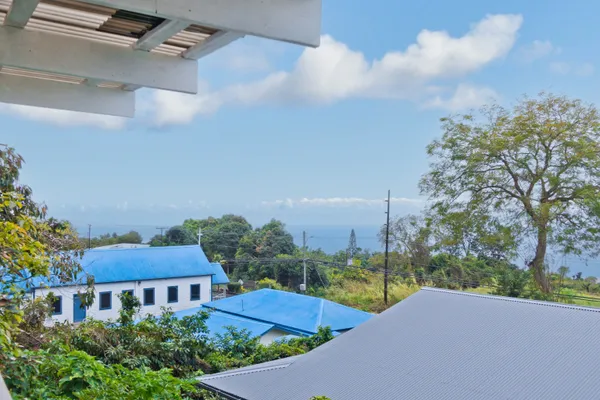 a view of a house with a yard and sitting area