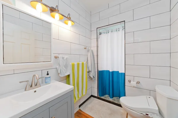 a bathroom with a sink toilet and shower
