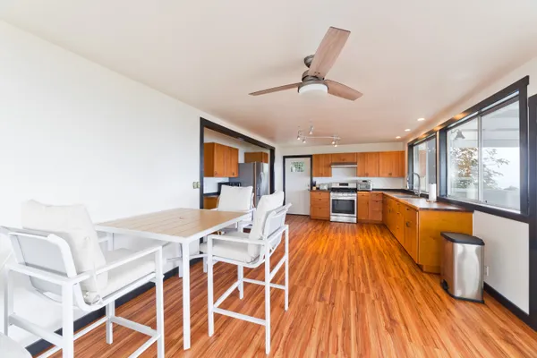 a large white kitchen with a large window