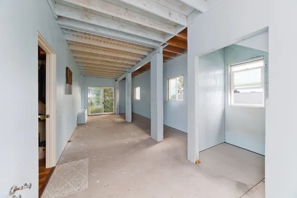 a view of a hallway with wooden shelves