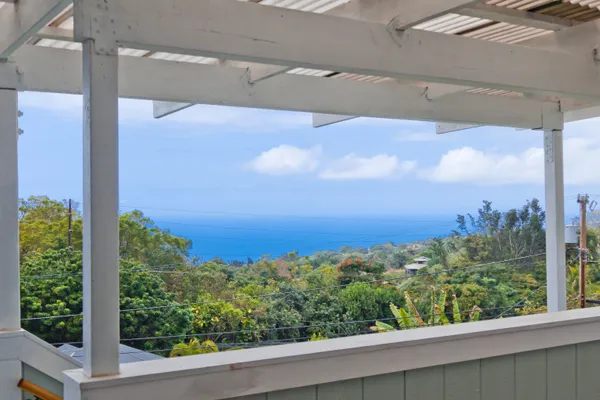 a view of a chair and table in backyard of the house