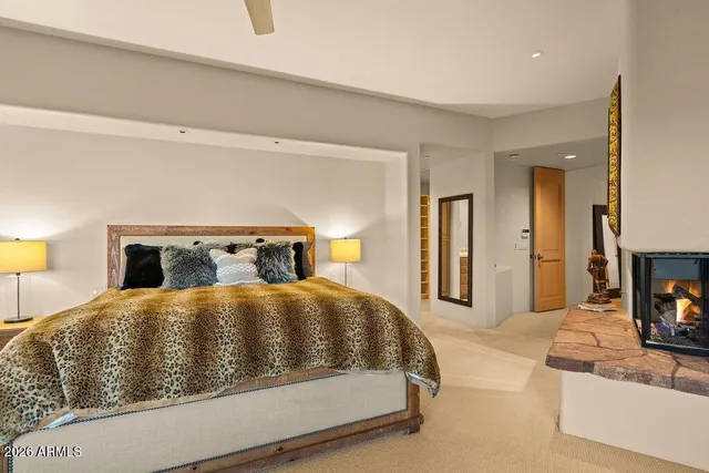 a bedroom with a bed and a night stand