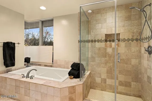 a bathroom with a tub and a shower