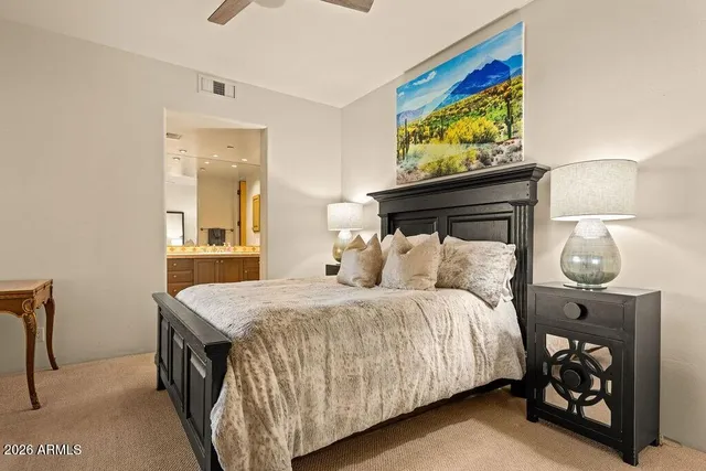 a bedroom with a bed and a painting on the wall