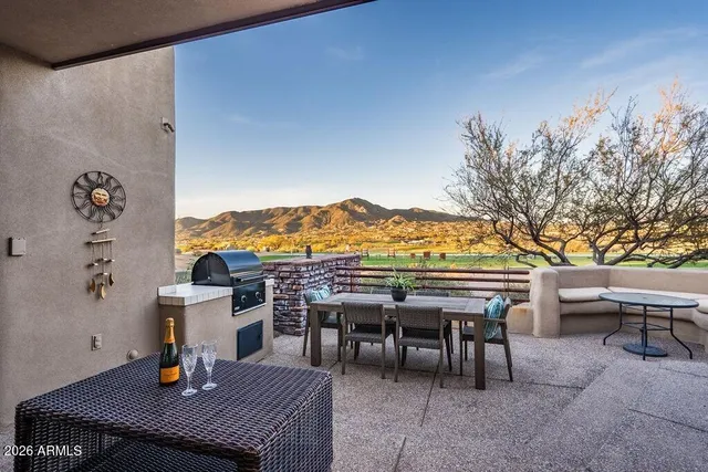 a view of a chairs and table in the patio
