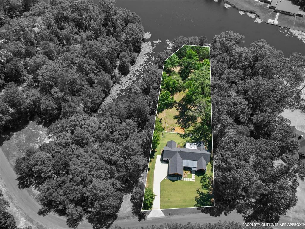 800 John Dean Road Gilmer, TX 75644 - Photo 3 of 40 a view of a house with a yard
