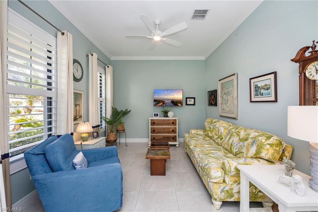 1287 Manado Drive Naples, FL 34113 - Photo 12 of 32 a living room with furniture and a large window