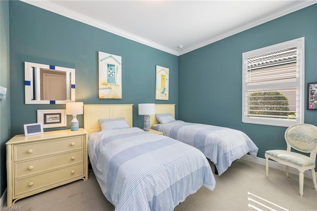 1287 Manado Drive Naples, FL 34113 - Photo 16 of 32 a bedroom with two beds and painting on the wall