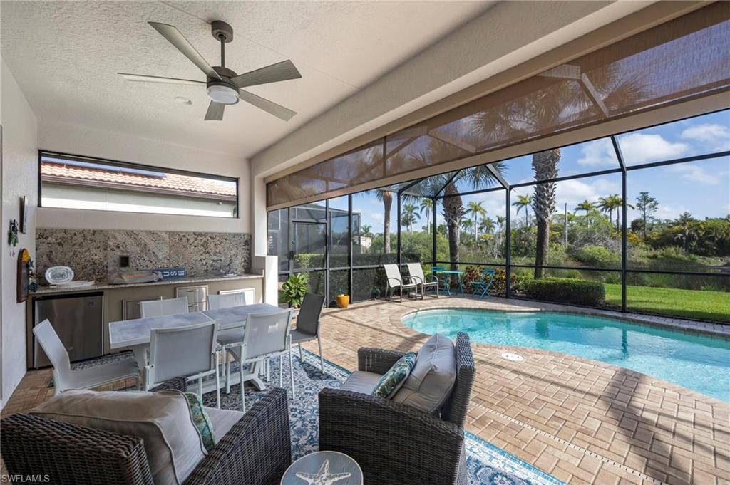 1287 Manado Drive Naples, FL 34113 - Photo 19 of 32 a living room with furniture and a floor to ceiling window