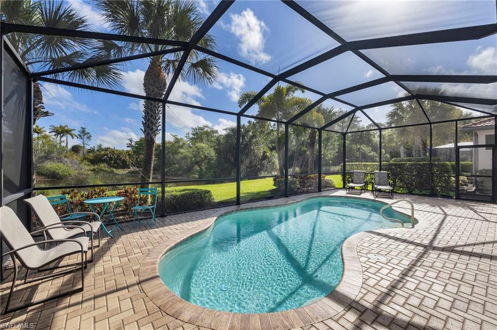 1287 Manado Drive Naples, FL 34113 - Photo 21 of 32 a view of a swimming pool with a patio