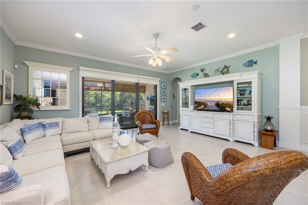 1287 Manado Drive Naples, FL 34113 - Photo 4 of 32 a living room with furniture and a flat screen tv