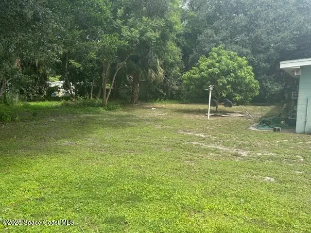 a backyard of a house with lots of green space
